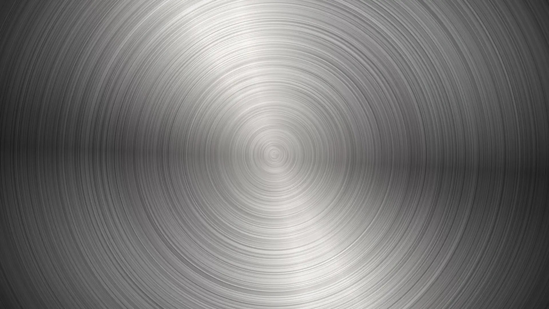 A close up of the brushed metal texture of a clock.