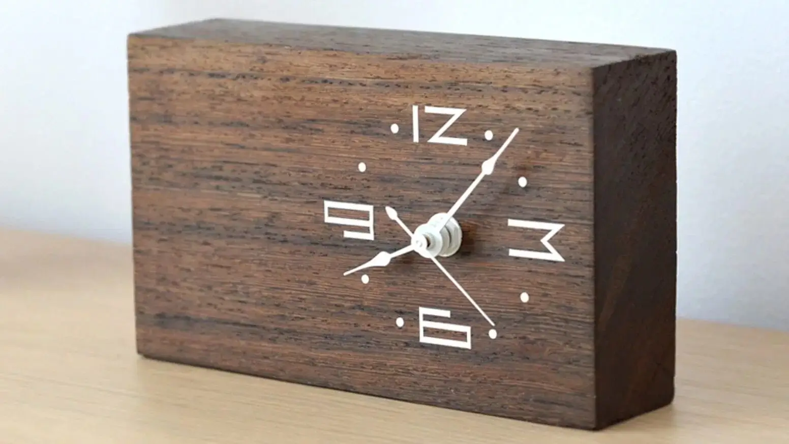 A close up of the natural wood grain of a clock.
