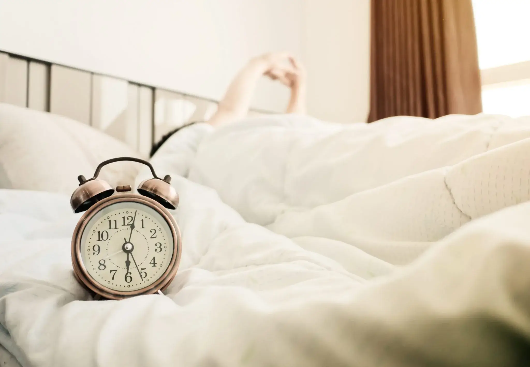 A beautifully styled bedside table featuring an EverTime alarm clock.