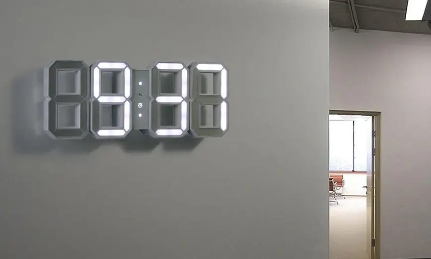 A minimalist clock in a bright, airy office space.